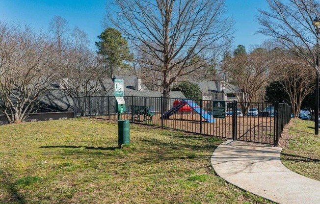 a park with a playground and a sidewalk