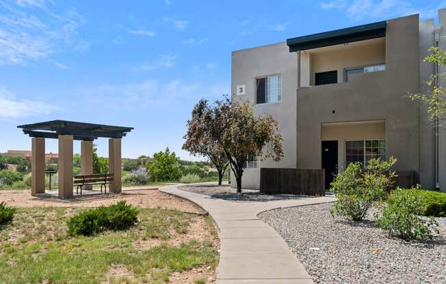 a house with a walkway and a bench in front of it