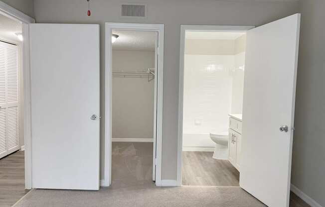 a bedroom with a bathroom and a closet