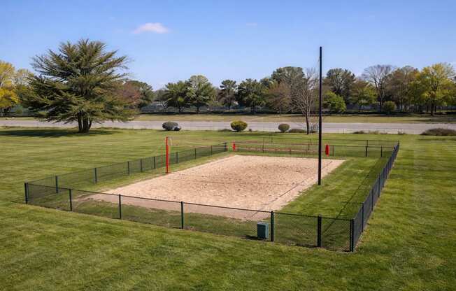 A baseball field with a red pole in the outfield.
