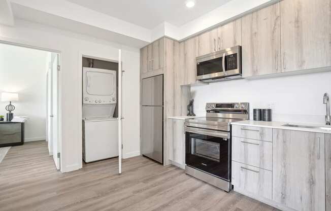 a kitchen with wooden cabinets and stainless steel appliances