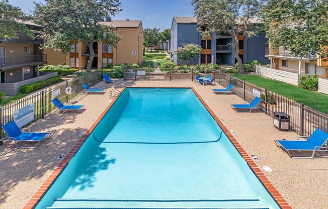 a group of lawn chairs sitting next to a pool