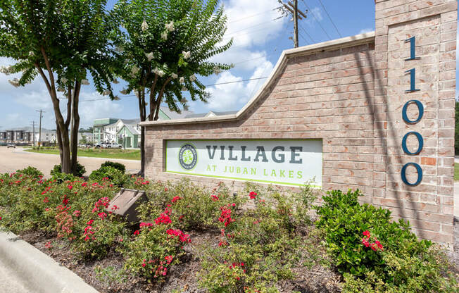welcome sign at Village at Juban Lakes Apartments