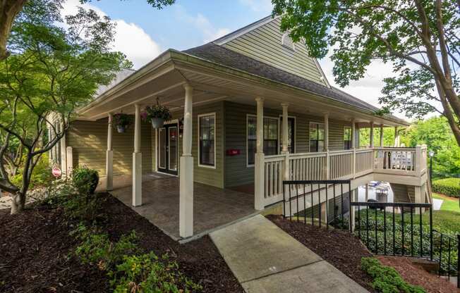 the front porch of a house with a porch swing