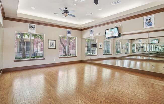 A room with wooden floors and a ceiling fan.