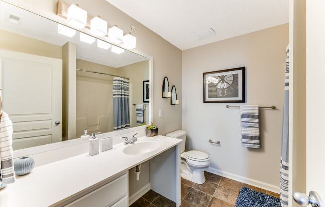 Bathroom with large vanity and bright lights at The Reserves of Thomas Glen, Shepherdsville, KY, 40165