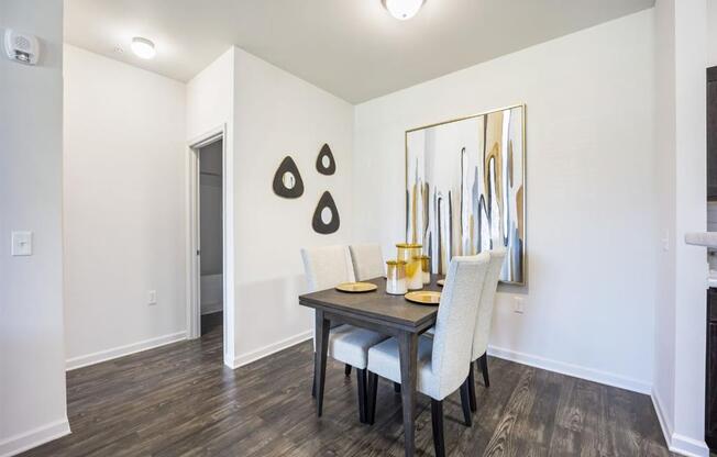 a dining room with a table and chairs at The Maddox Apartments, Centerton, AR, 72719