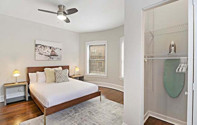 A bedroom with a large bed and a ceiling fan.