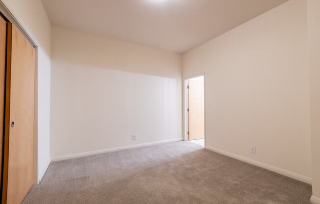 a bedroom with white walls and carpet at 26 West, Managed by Buckingham Urban Living, Indianapolis