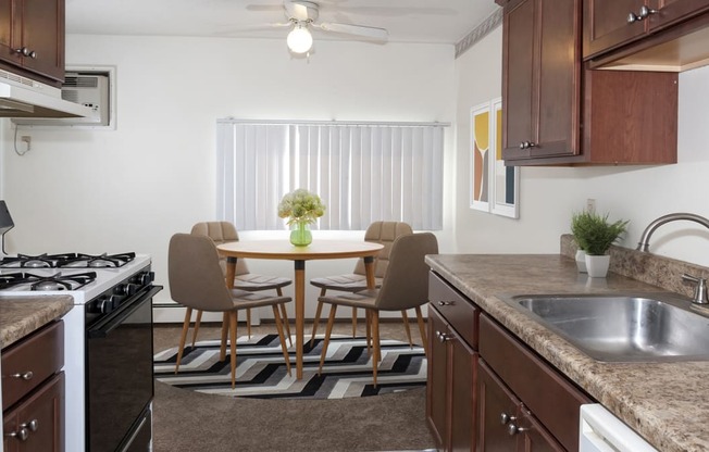 a kitchen and dining room with a table and chairs