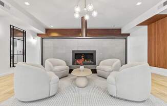 A modern living room with a fireplace and grey sofas.