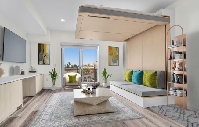 a living room with a couch and a coffee table in front of a window