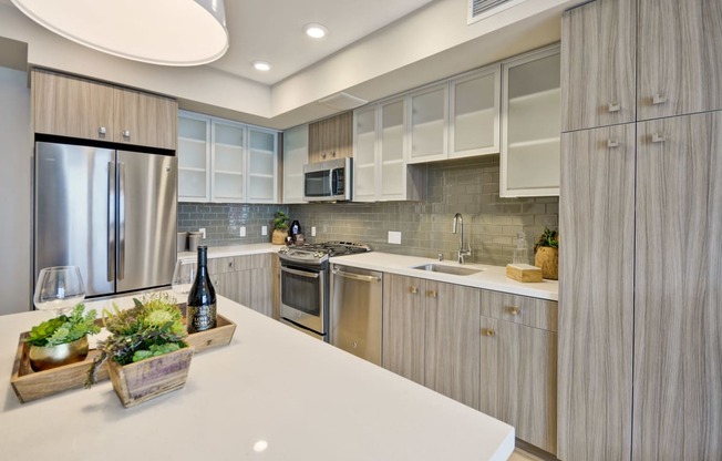a kitchen with stainless steel appliances and white counter tops at L Seven, San Francisco, California 94103