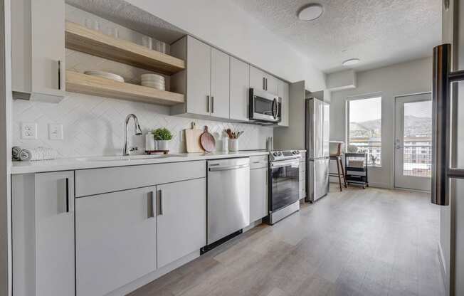 an open kitchen with white cabinets and stainless steel appliances