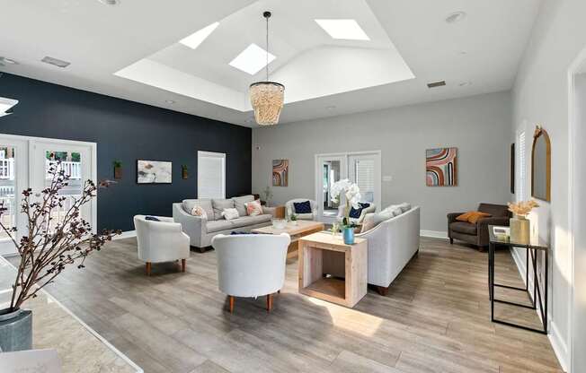 A living room with a white couch and a wooden coffee table.