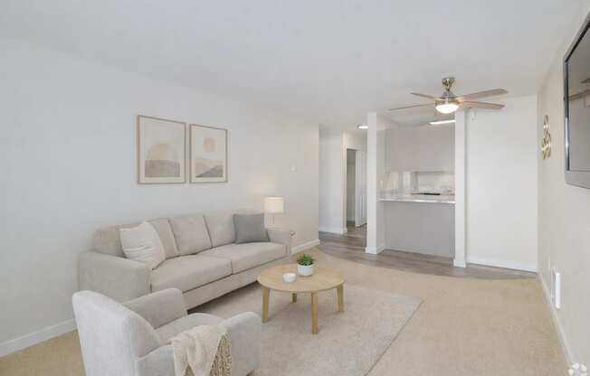 A living room with a couch, chair, and coffee table.