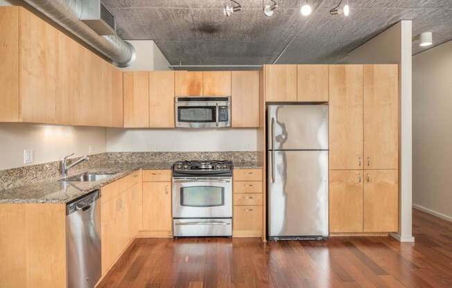 A kitchen with wooden cabinets and stainless steel appliances.