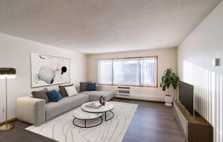 a living room with a couch and a coffee table. Fargo, ND North Manor Apartments