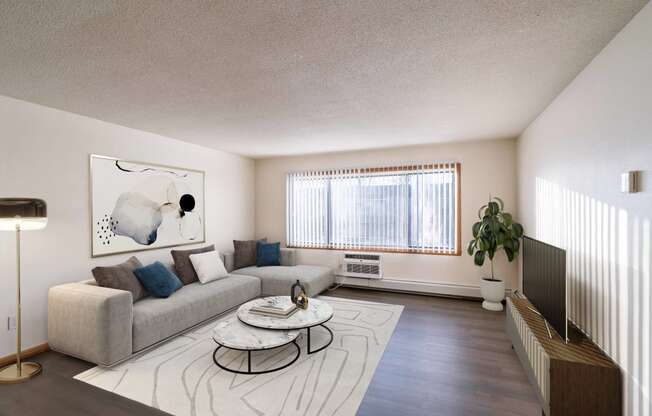 a living room with a couch and a coffee table. Fargo, ND North Manor Apartments