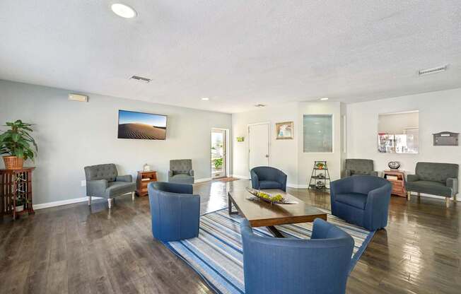 A living room with a blue couch and a wooden coffee table.