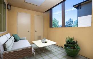 a small patio with a couch and a coffee table