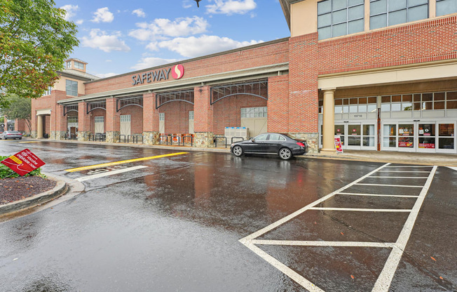 Safeway store with a car parked in front.