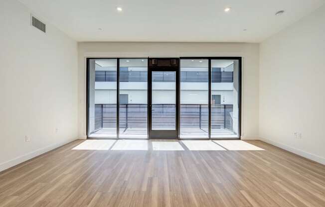 a living room with a sliding glass door to a pool
