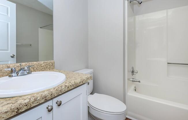 a room with a sink and a mirror