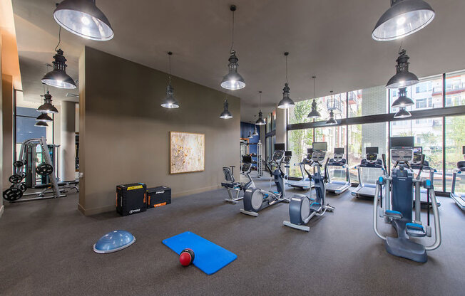 Fitness center with treadmills and other exercise equipment at Highgate At The Mile Apartments