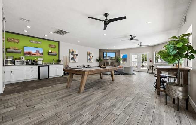 A spacious kitchen and dining area with wooden flooring and modern appliances.