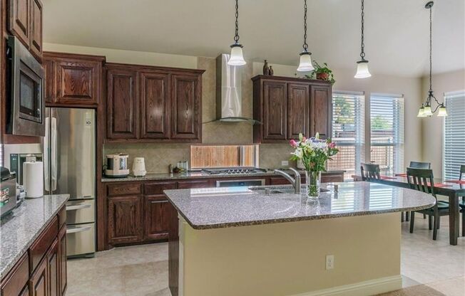Grand entry, Open floor plan with high ceiling, Spacious rooms, Elegant kitchen featuring stainless steel appliances.