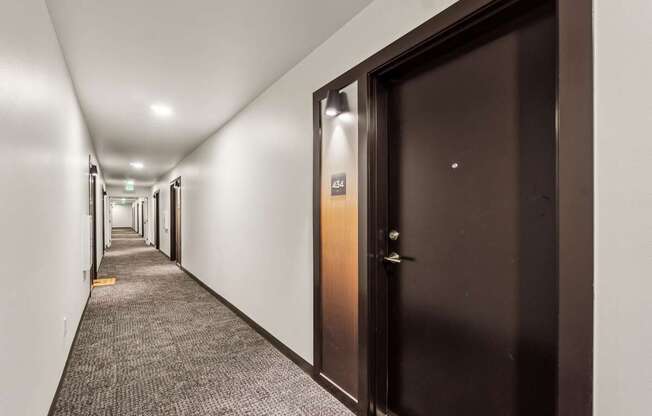 A hallway with a brown door and a sign that says "ASA".