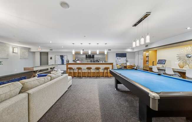 Resident lounge with billiards table and comfortable seating at River 595