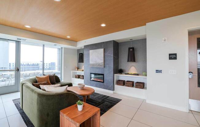 A modern living room with a green couch and a wooden coffee table.