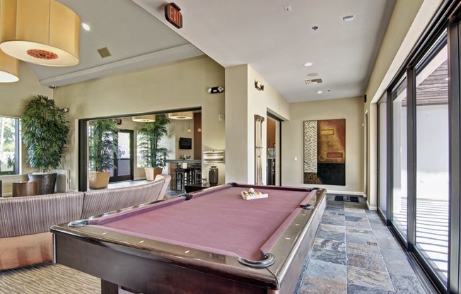 a pool table in the clubhouse at cobblestone apartments