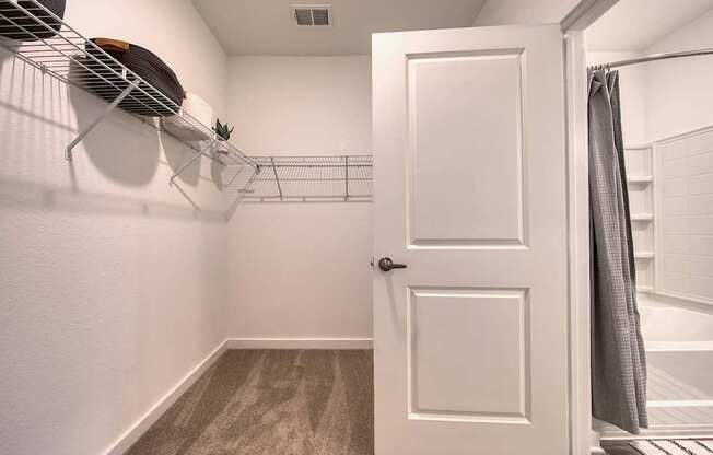 A white door is open to a bathroom.