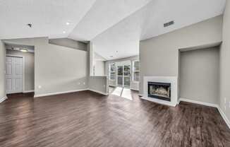 the living room has a fireplace and hardwood floors