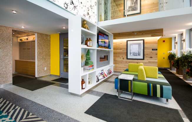 a living room with yellow walls and a green couch at Ann Arbor City Club, Michigan, 48104