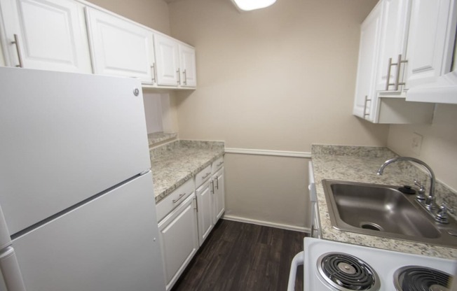 This is a photo of the kitchen in the 653 square foot 1 bedroom apartment at Harvard Square Apartments, in Dallas, TX.