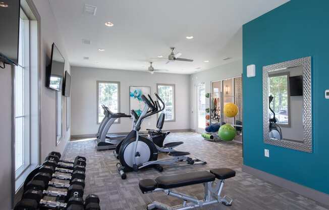 a home gym with a blue accent wall  at The Madison Franklin, Franklin, 37064