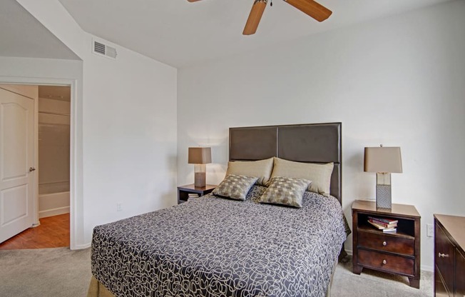 a bedroom with a bed and a ceiling fan