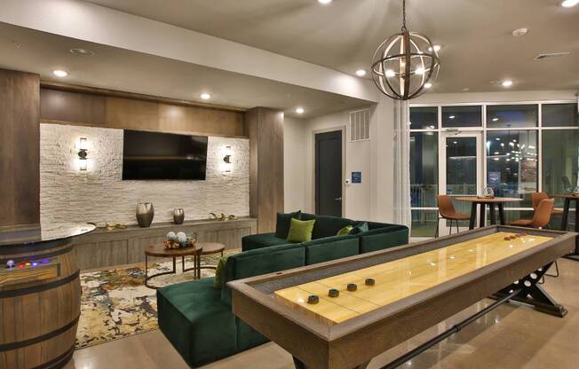 a living room with a pool table and a television