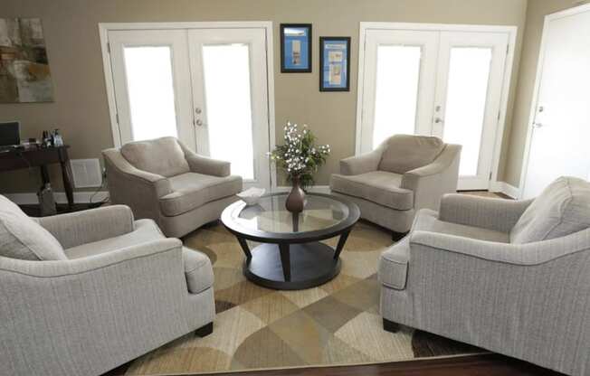 a living room with couches and chairs