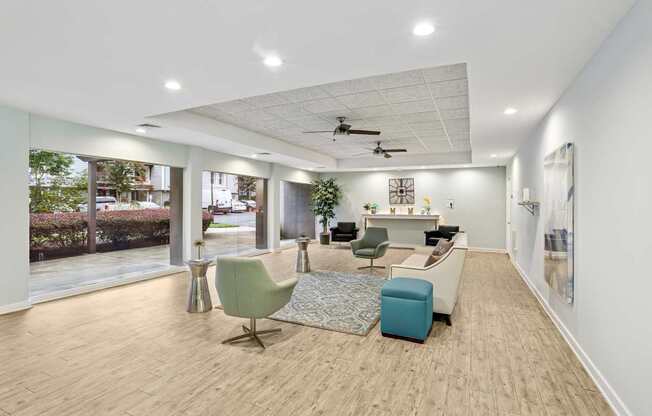 A spacious room with a green chair and a blue ottoman.
