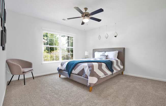 a bedroom with a bed and a ceiling fan
