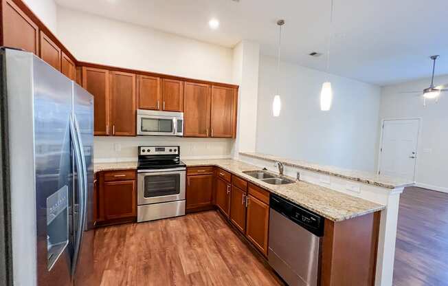 a kitchen with wooden cabinets and stainless steel appliances