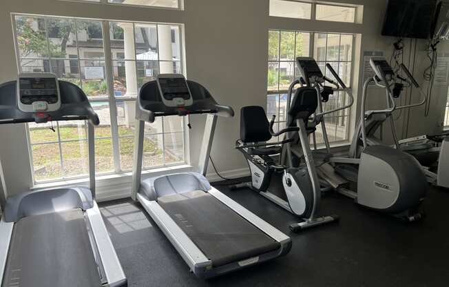 a gym with treadmills and other exercise equipment