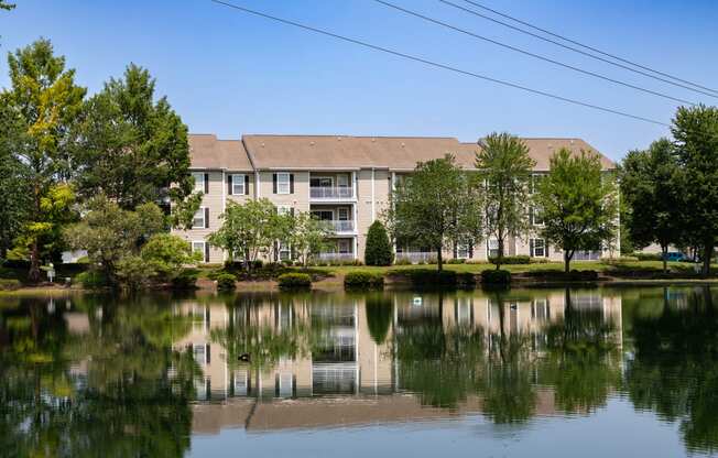 a view of a lake with an apartment building in the background