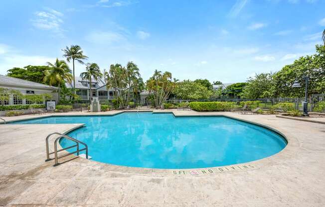 a swimming pool at a resort with palm trees