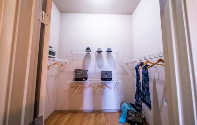 a walk in closet in a small room with clothes and shoes at Azul Baldwin Park, Orlando